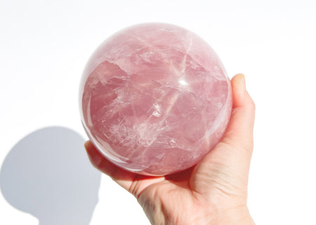 This rose quartz sphere displays a giant 6-sided star when in direct sunlight.